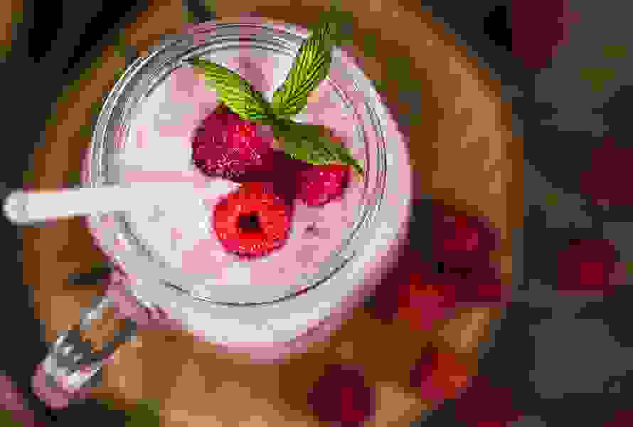 Ein frischer Himbeersmoothie im Glas von oben – ideal, wenn der Magen weniger Platz hat, aber Nährstoffe gefragt sind.