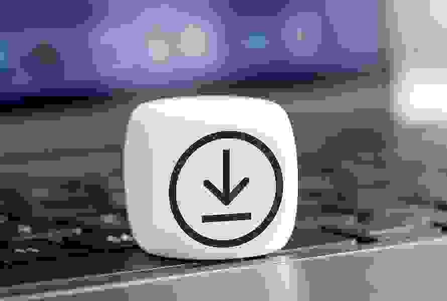 Un cube blanc avec le symbole de téléchargement est posé sur un clavier – accès immédiat aux documents importants.