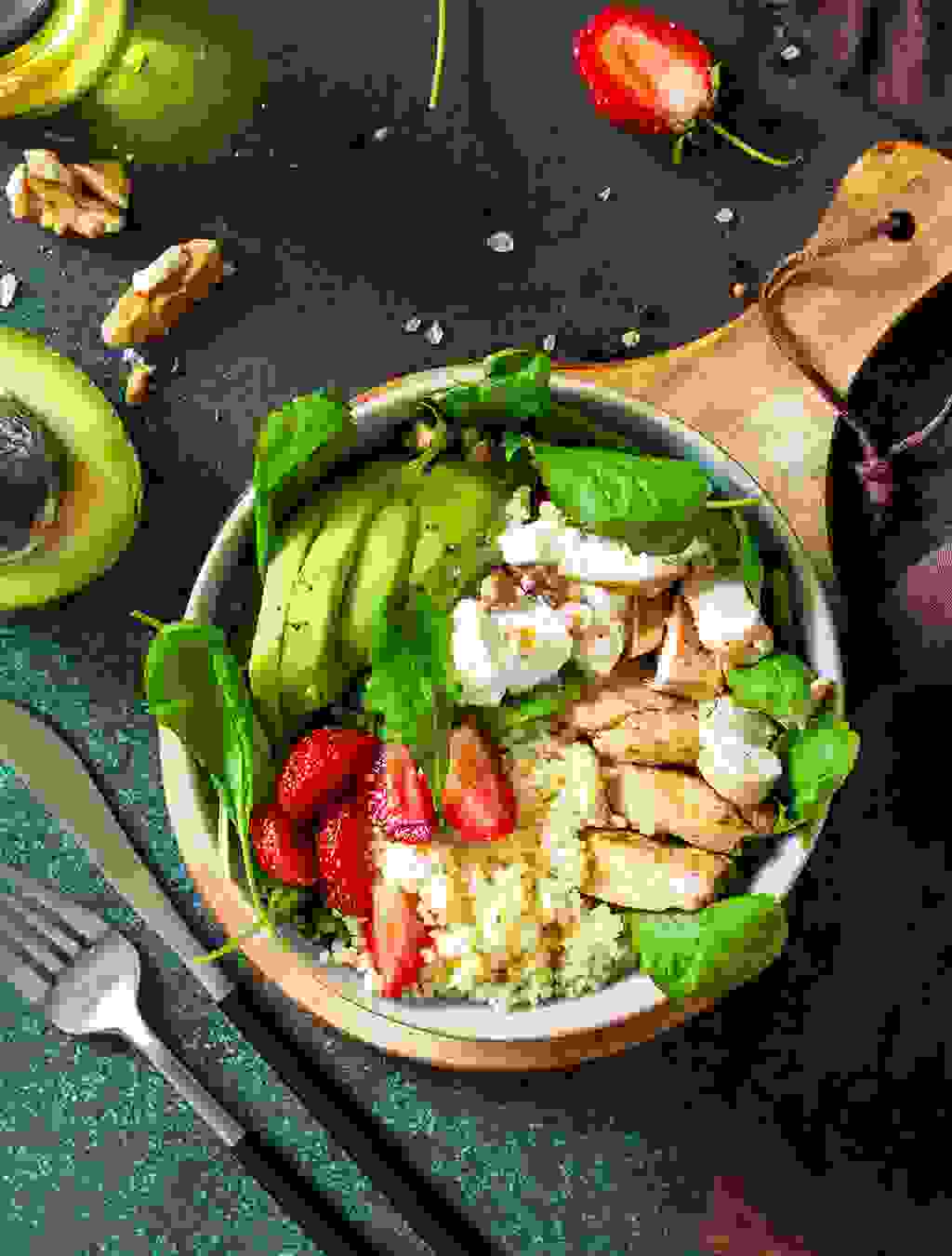 Ein gesunder Mix aus Couscous, gebratenen Pouletstreifen, Avocadoscheiben, Spinat, Erdbeeren und Joghurt – vollwertig und lecker für Schwangere.